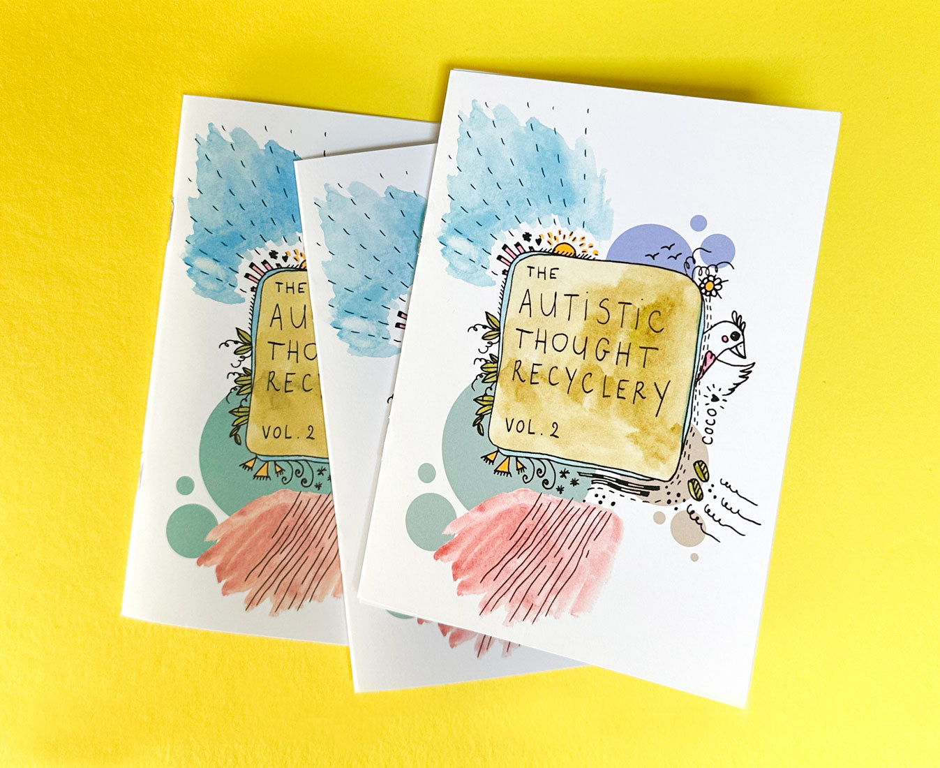 Three zines 'Autistic Thought Recyclery Vol. 2' art and illustration on a yellow background