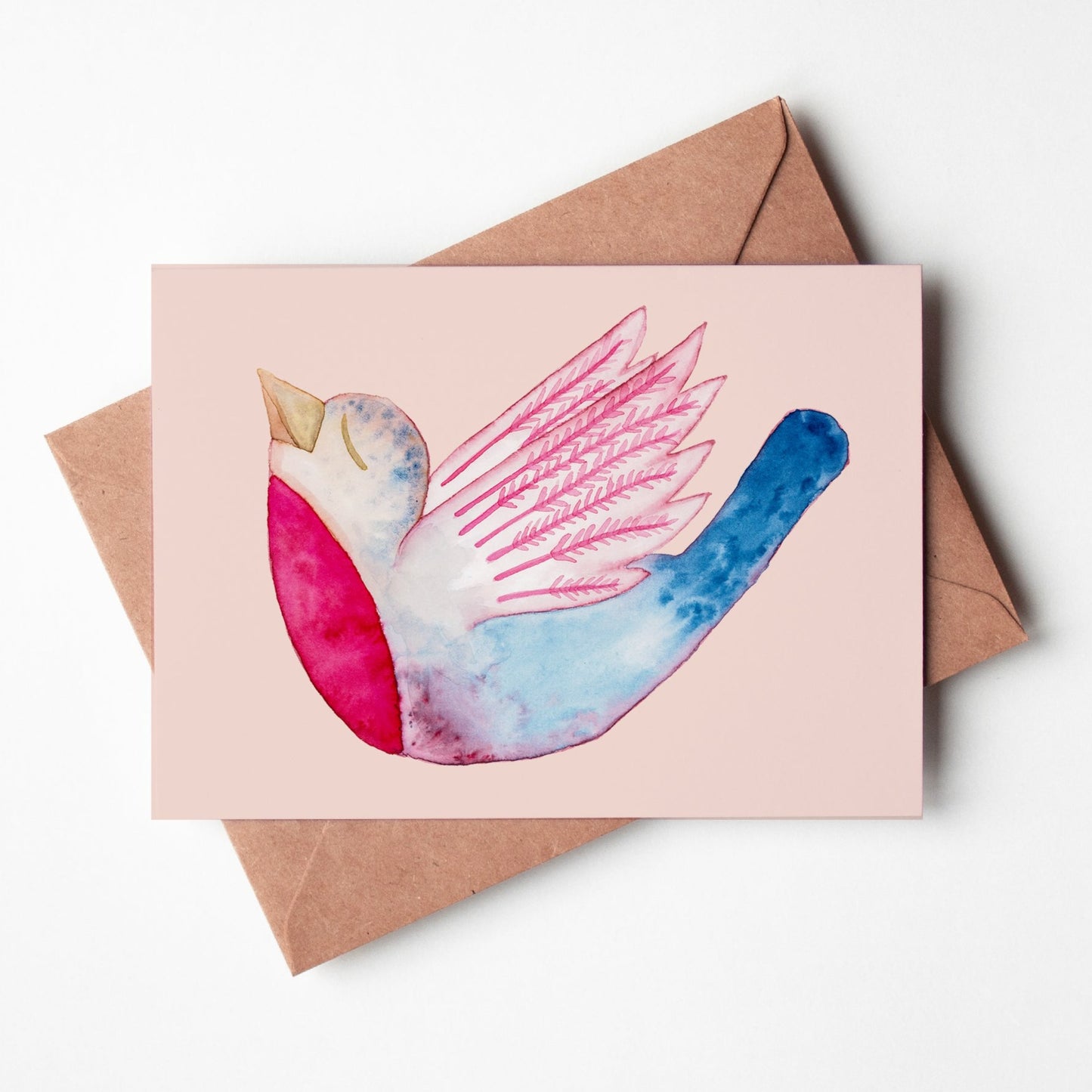 Greeting card with a watercolor bird looking zen, relaxed, on a light pink background, with spread wings. Dominant colors are pink and blue.